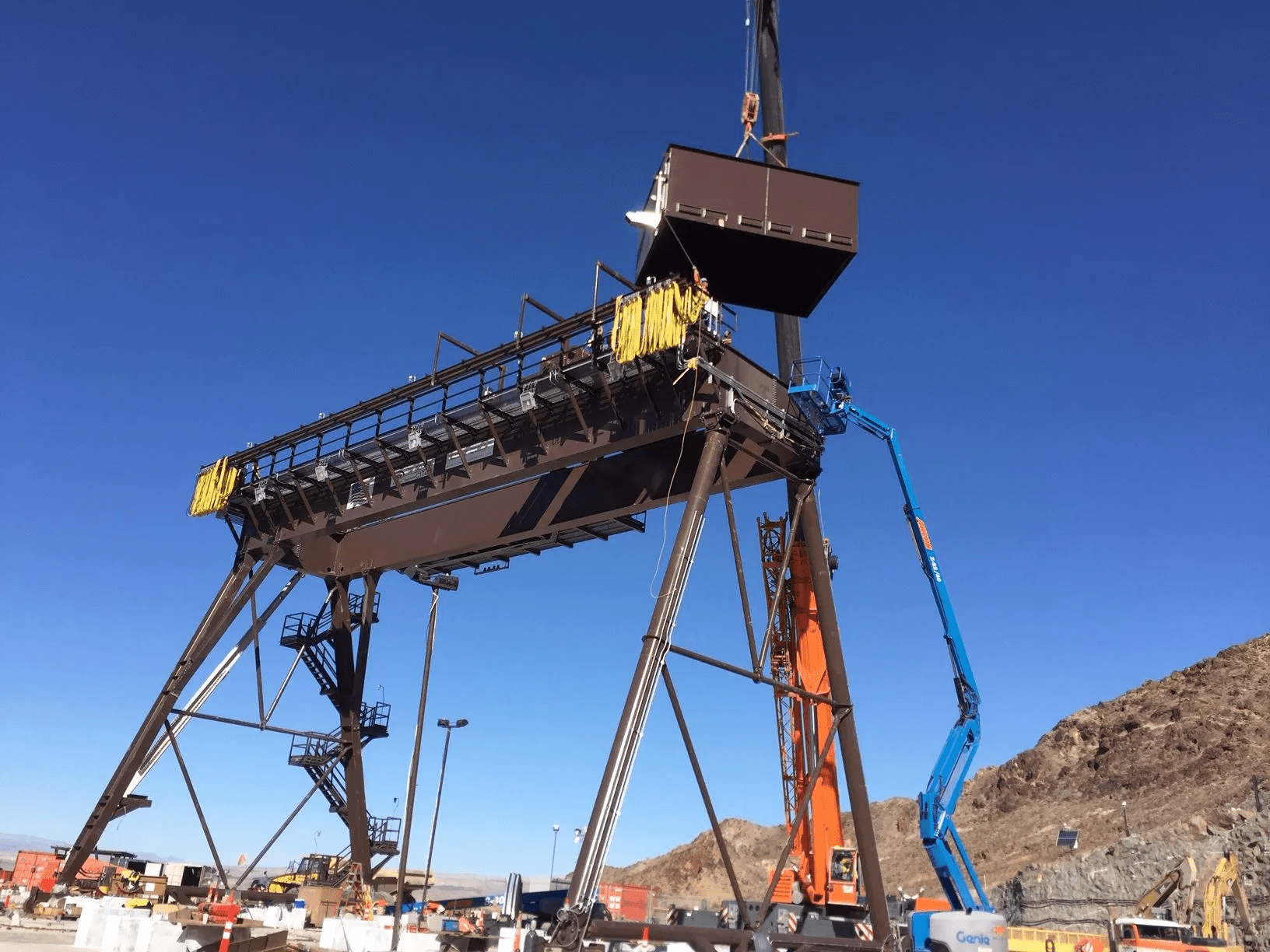 Crane being used to dismantle a very tall piece of machinery